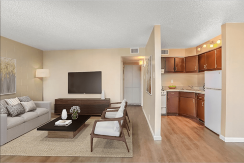 a living room and kitchen with a couch and a table